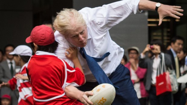 Mayor of London Boris Johnson knocks over 10 year-old Toki Sekiguchi during a street rugby tournament.