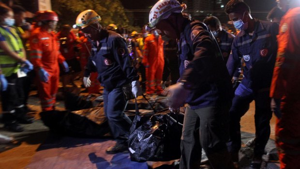 Rescuers carry a body bag after an explosion at a market in Davao City on Friday night.