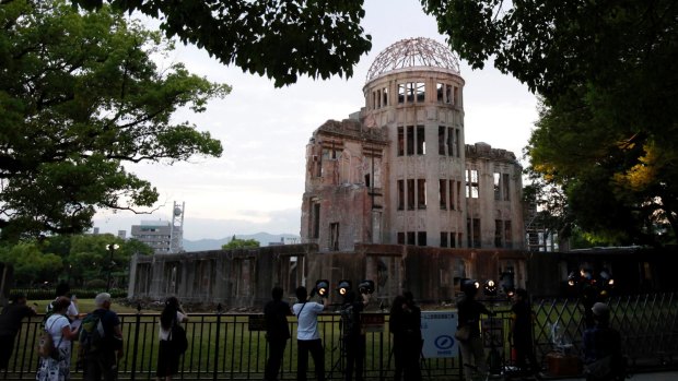 People visit the gutted Atomic Bomb Dome at the Hiroshima Peace Memorial Park in 2016.
