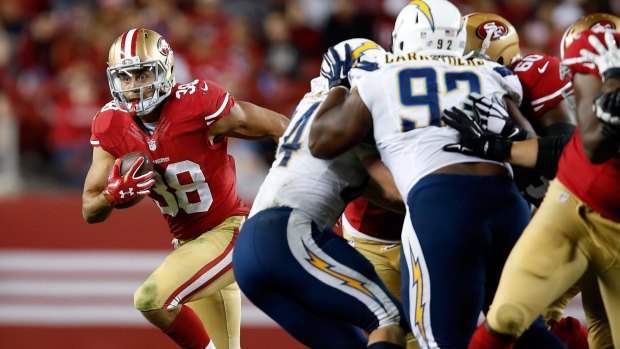 On the charge: Jarryd Hayne looks for space against the San Diego Chargers on Friday.