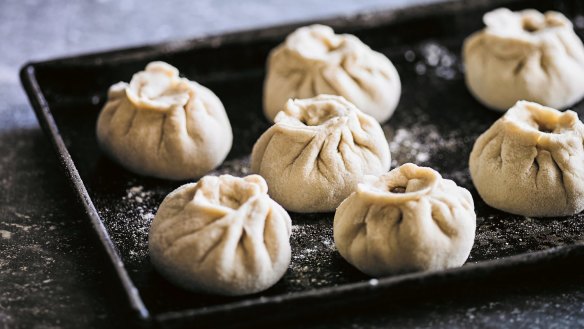 Raw baozi ready to be pan-fried then steamed.