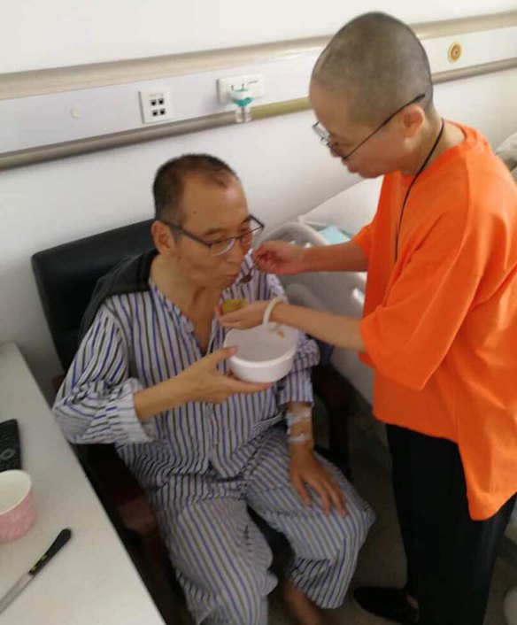 In this undated handout photo,  Liu Xiaobo, left, attended to by his wife Liu Xia in a hospital in China. Liu Xiaobo was released from prison on medical parole after being diagnosed with late-stage liver cancer. But he was not allowed to leave the country to get medical treatment in the West.