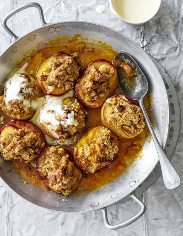 Serve the crumble-topped baked peach halves with cream.
