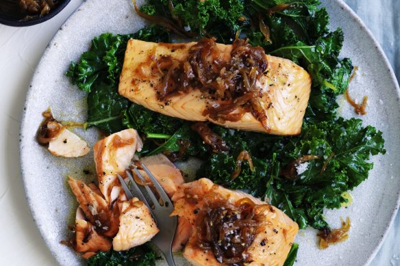 Quick, healthy dinner: Salmon fillets with caramelised onion and wilted greens.