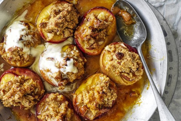 Serve the crumble-topped baked peach halves with cream.