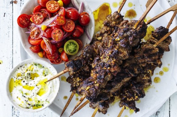 Spicy lamb skewers with cucumber yoghurt and cherry tomatoes.