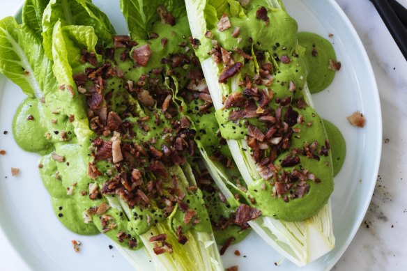 Green goddess dressing drizzled over lettuce with bonus bacon bits.