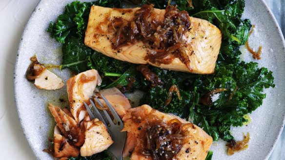 Salmon fillets with caramelised onions and wilted greens.
