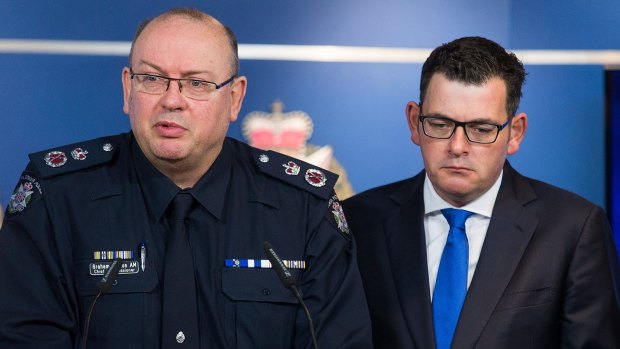 Chief Commissioner Graham Ashton, seen here with Premier Daniel Andrews after June's Brighton shooting, is due back on duty in mid-January.
