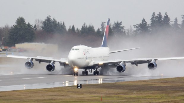 A Delta 747 filled with employees and customers arrives at Boeing's plant in Everett in the first in a series of farewell flights.