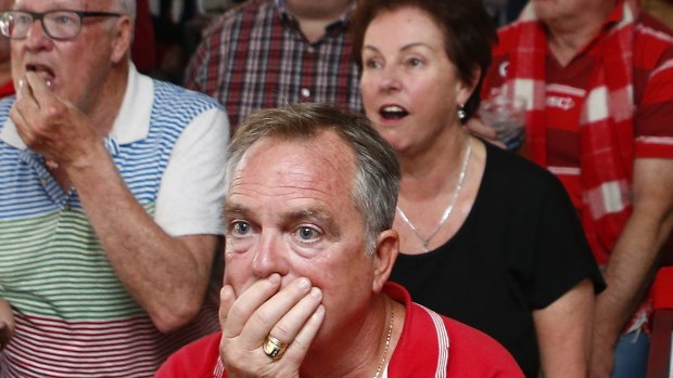 A Sydney Swans fan at the Warren View Hotel in Enmore reacts after his team lost the AFL grand final.