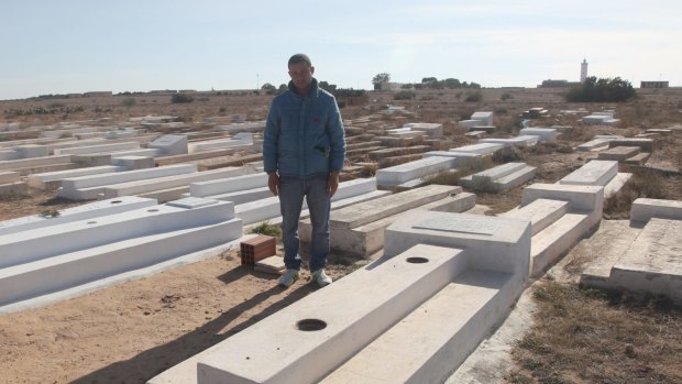 Lotfi Bouazizi, 35, at his famous cousin Mohamed's grave in Sidi Bouzid. Lotfi was in Italy searching for work when his cousin's suicide sparked the Arab Spring. He returned in the hope that the Jasmine Revolution would improve life in Tunisia.