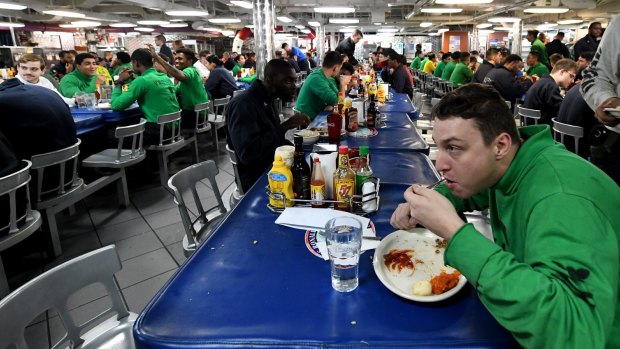 Some of the 30,000 personnel involved in Operation Talisman Saber eat on-board the USS Ronald Reagan in the Coral Sea.