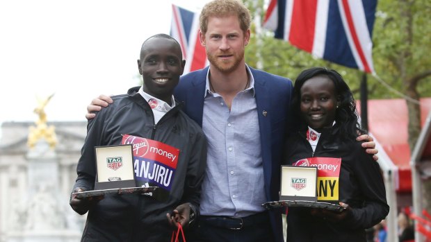 Prince Harry with the winners of the London Marathon, Daniel Wanjiru and Mary Keitany.