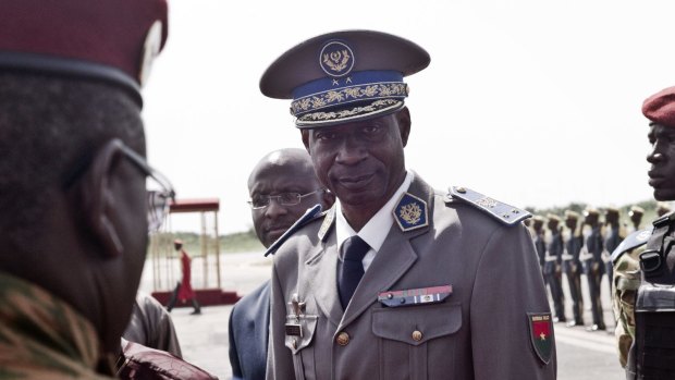 Burkina Faso coup leader Gilbert Diendere greets people at the airport.