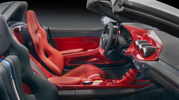 The interior features is designed around the driver with red trim for the seat and dashboard.