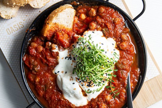 Shakshuka - eggs baked in chickpea and onion-mined tomato sauce.