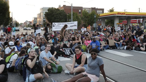 Protesters sit in a street in University City, Missouri in response to a not guilty verdict in the trial of former St Louis Police officer Jason Stockley.