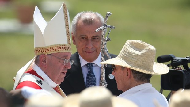 Pope Francis greets Cuban President Raul Castro after holding a Mass in the Plaza de la Revolution in Holguin, Cuba.