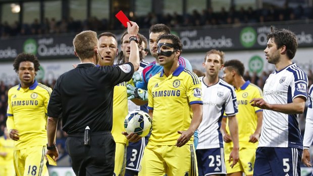 Fabregas is shown a red card by referee Mike Jones.