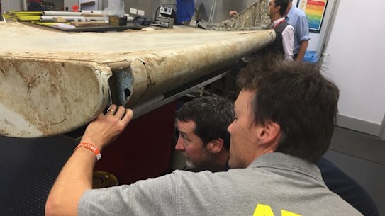 Malaysian and Australian investigators examine the piece of aircraft debris found on Pemba Island off the coast of Tanzania.