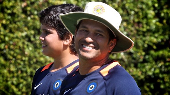 Growing up fast: Arjun Tendulkar, pictured with father Sachin in 2012.