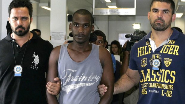 Killing spree ends: Sailson Jose das Gracas, 26, is escorted by police in Nova Iguacu near Rio de Janeiro.