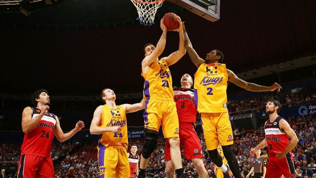 Contested: Jeromie Hill of the Kings takes a rebound against the Hawks.