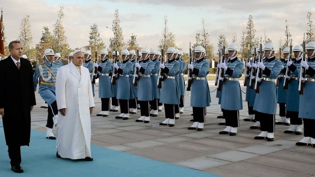 Pomp and ceremony:  Pope Francis and Turkish President Recep Tayyip Erdogan, left, walk by the honour guard at the presidential palace in Ankara.