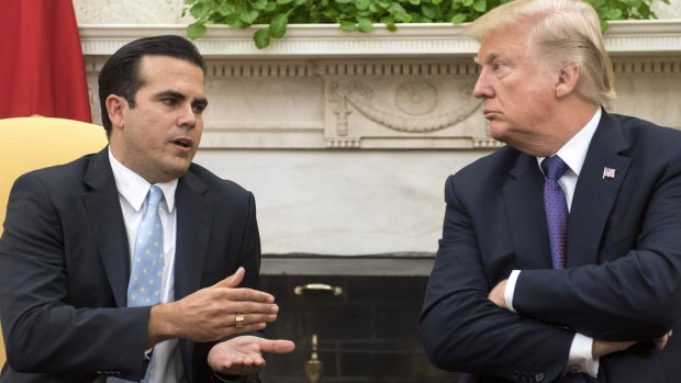 Ricardo Rossello, governor of Puerto Rico, left, speaks as US President Donald Trump listens during a meeting in the Oval Office of the White House in Washington, DC.