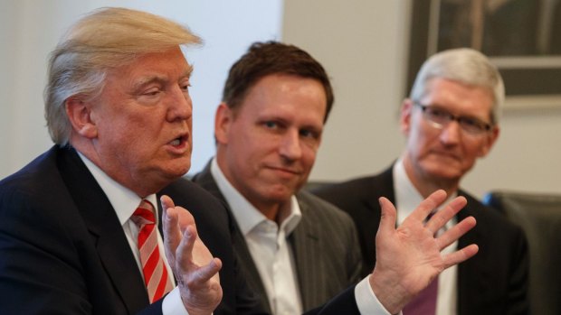 Peter Thiel, centre, listens as Donald Trump speaks. Apple CEO Tim Cook sits at right. 