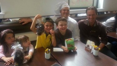 Children (from left) Paige Rowney, Kate Hinchcliff, Henry Hinchcliff and Zachary Rowney with a Lindt chef and manager Tori Johnson.