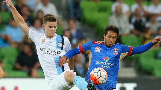 Connor Chapman, of Melbourne City, and the Jets' Mitch Cooper compete for the ball.