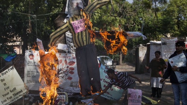 Activists hang and burn an effigy of Mukesh Singh.