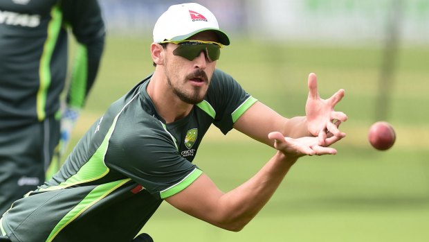 No pink fan: Mitchell Starc catches the ball  during a training session in England.