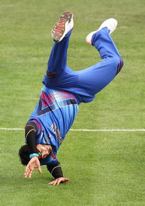 Flipping out:  Hamid Hassan does a cartwheel to celebrate the wicket of Kumar Sangakkara.