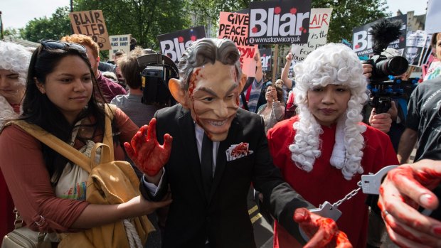 A demonstrator dressed as Tony Blair, with painted red hands and in handcuffs, protests Britain's involvement in the Iraq war in London on Wednesday.