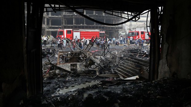 The aftermath on Sunday of a car bomb in Karada, a busy shopping district in the centre of Baghdad.