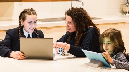 Cathy Filardo is seen helping her children, 13-year-old Siena and 5-year-old Massimo with their homework at home in Melbourne.