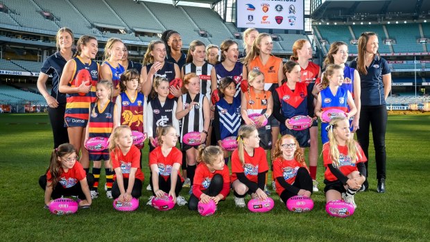 Daisy Pearce (far right) with fellow players and potential future stars at the launch of the league.