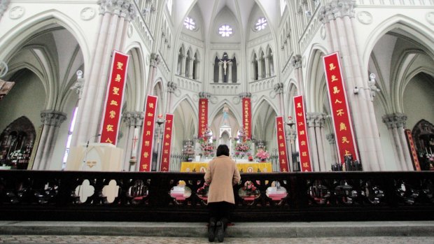 A Chinese Catholic prays at the state-sanctioned Saint Ignatius Cathedral in Shanghai. 