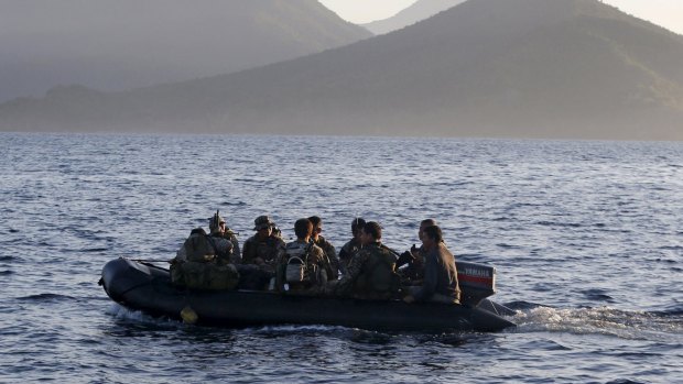 Philippine marines are transported on a rubber boat from a patrol ship, after a mission at the disputed Second Thomas Shoal, part of the Spratly Islands.