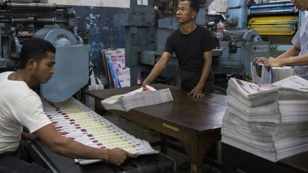 Staff oversee the printing of a Burmese-language newspaper in Yangon.