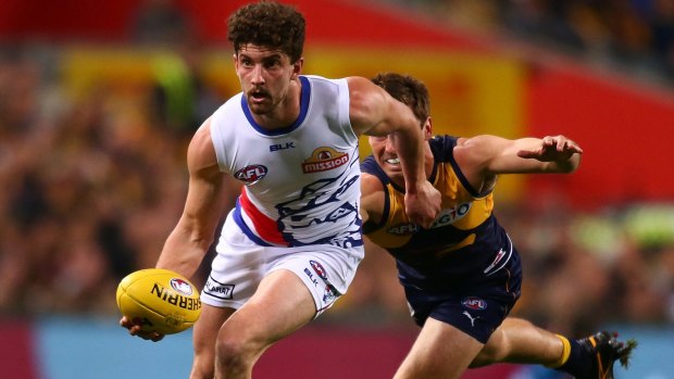 Tom Liberatore helps the Bulldogs to an elimination final win over West Coast last year. A last-round wildcard weekend could radically re-shape the first week of finals.