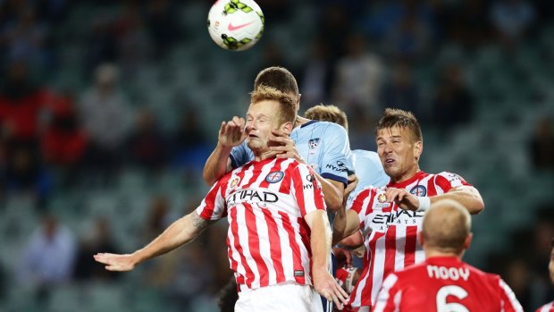 Tense struggle: Jack Clisby of Melbourne City heads the ball.