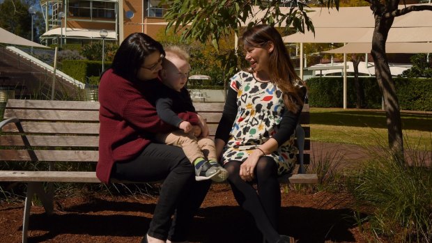 Amanda and Blake Darragh with paediatric radiation oncologist Jennifer Chard, in the gardens at the Children's Hospital at Westmead. 
