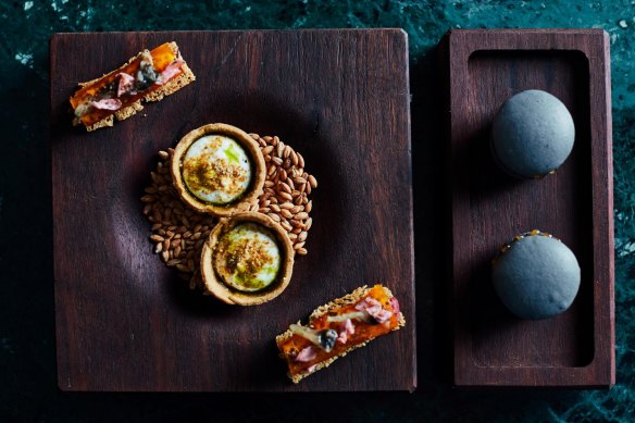 Opening snacks at Navi might include black garlic macarons (right).