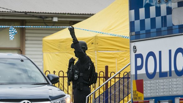 A police officer outside the house raided in  Braybrook.