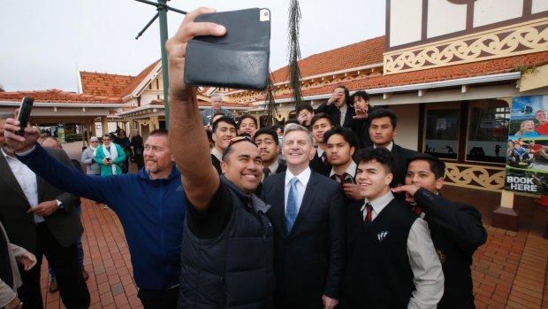 New Zealand PM Bill English poses for a selfie with high scholl boys in Rotorua. 