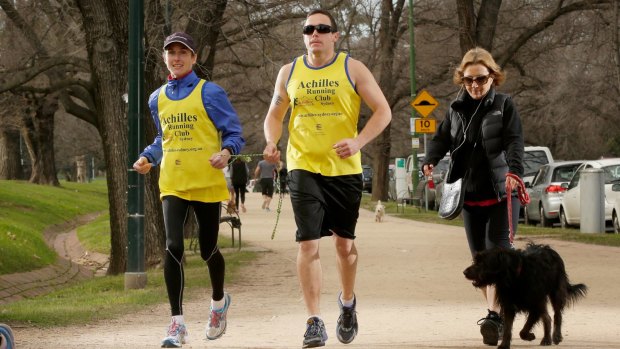 Blind runner Adam Koops training at the Tan track around the Royal Botanical Gardens with Achilles Running Club volunteer Amelia Griffith. 